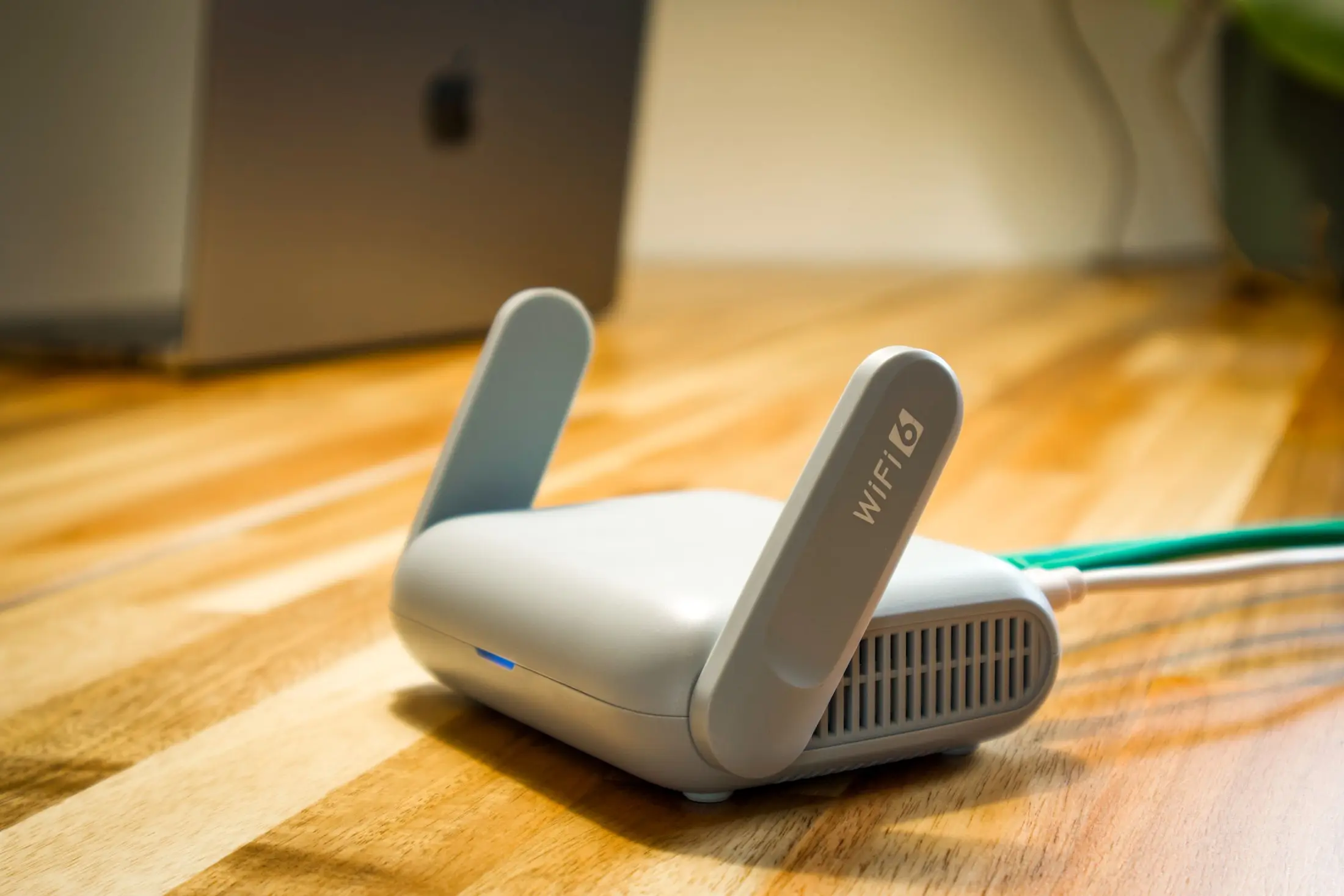 WLAN-Router mit angeschlossenem Netzwerkkabel auf einem Schreibtisch